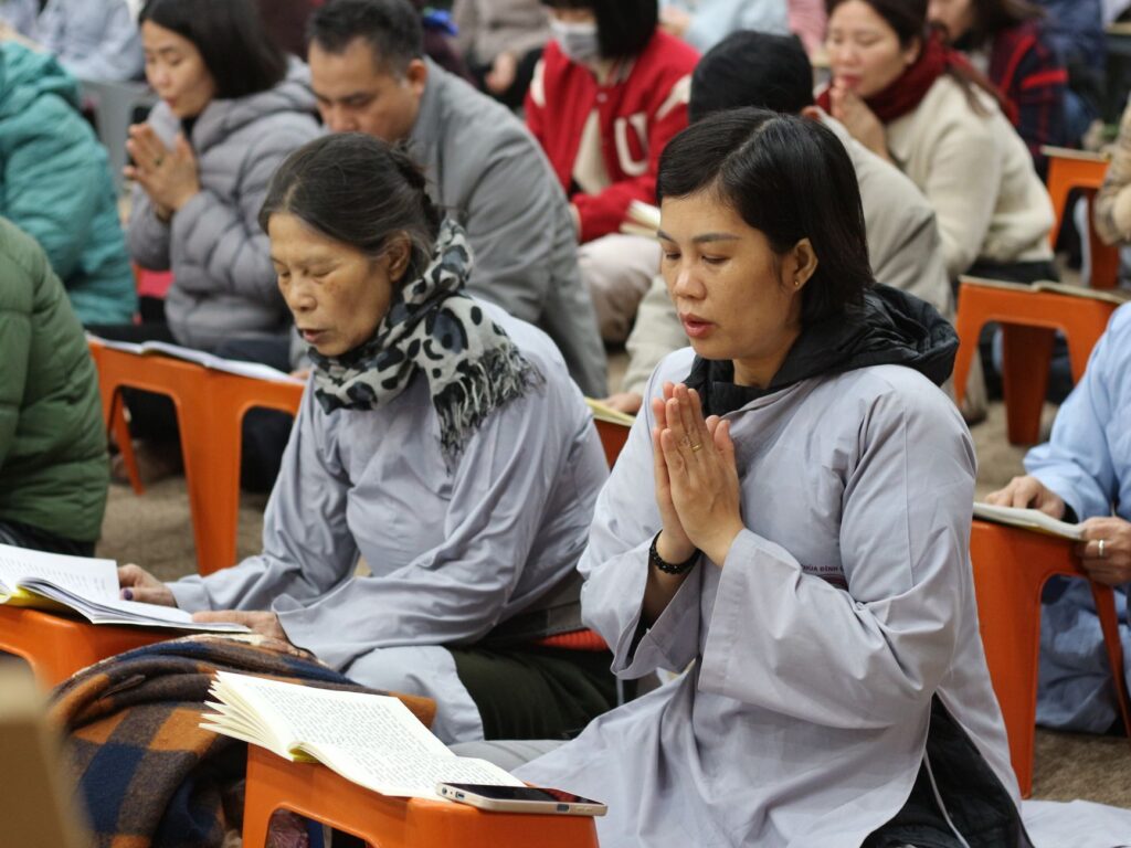 A group praying together illustrates the strength found in community support during uncertain times