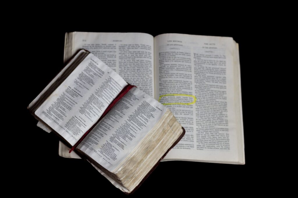 An open Bible resting on a wooden table, symbolizing the foundation of faith